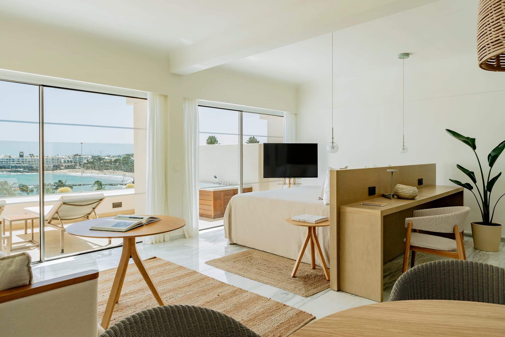 a room with a bed and a table and chairs