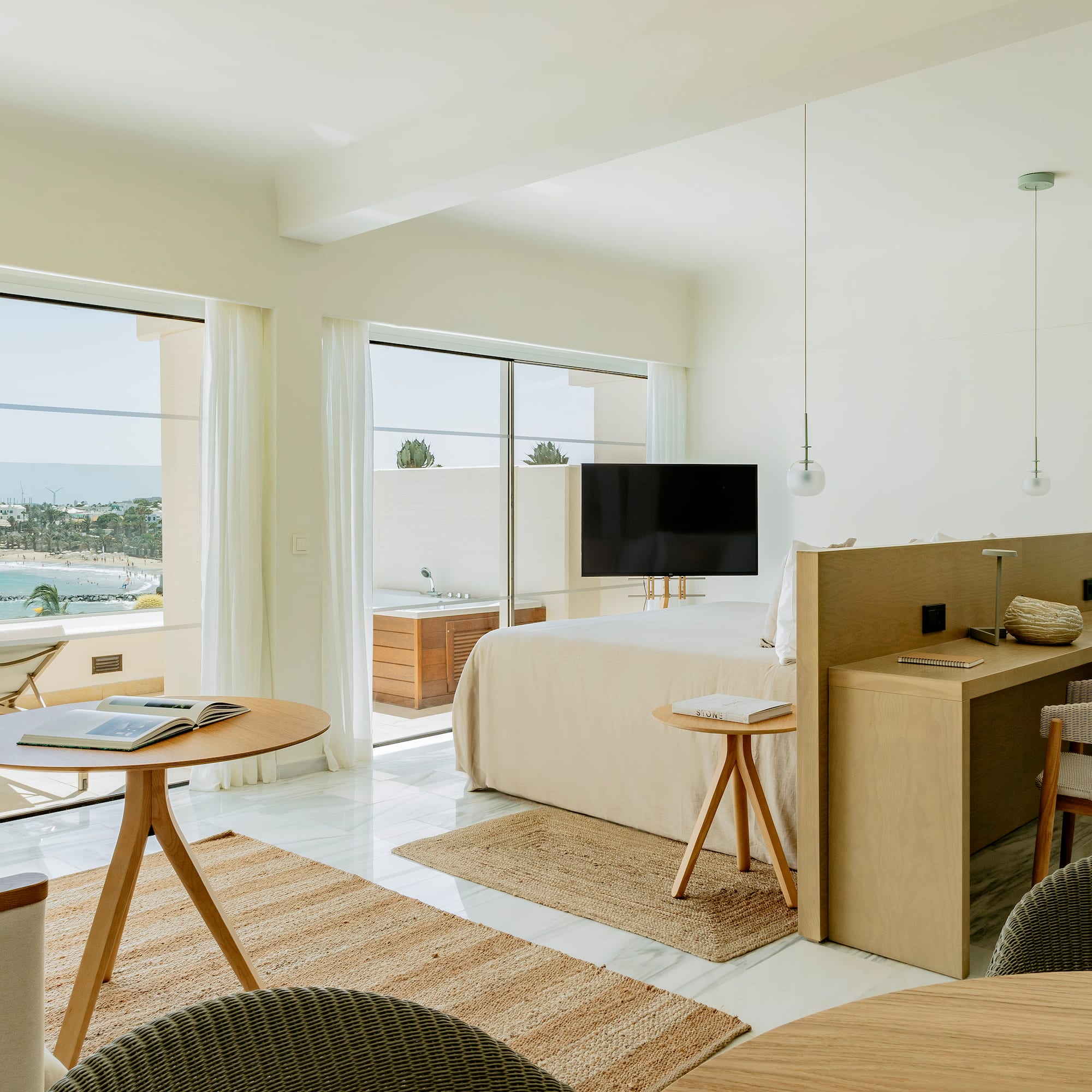 a room with a bed and a table and chairs