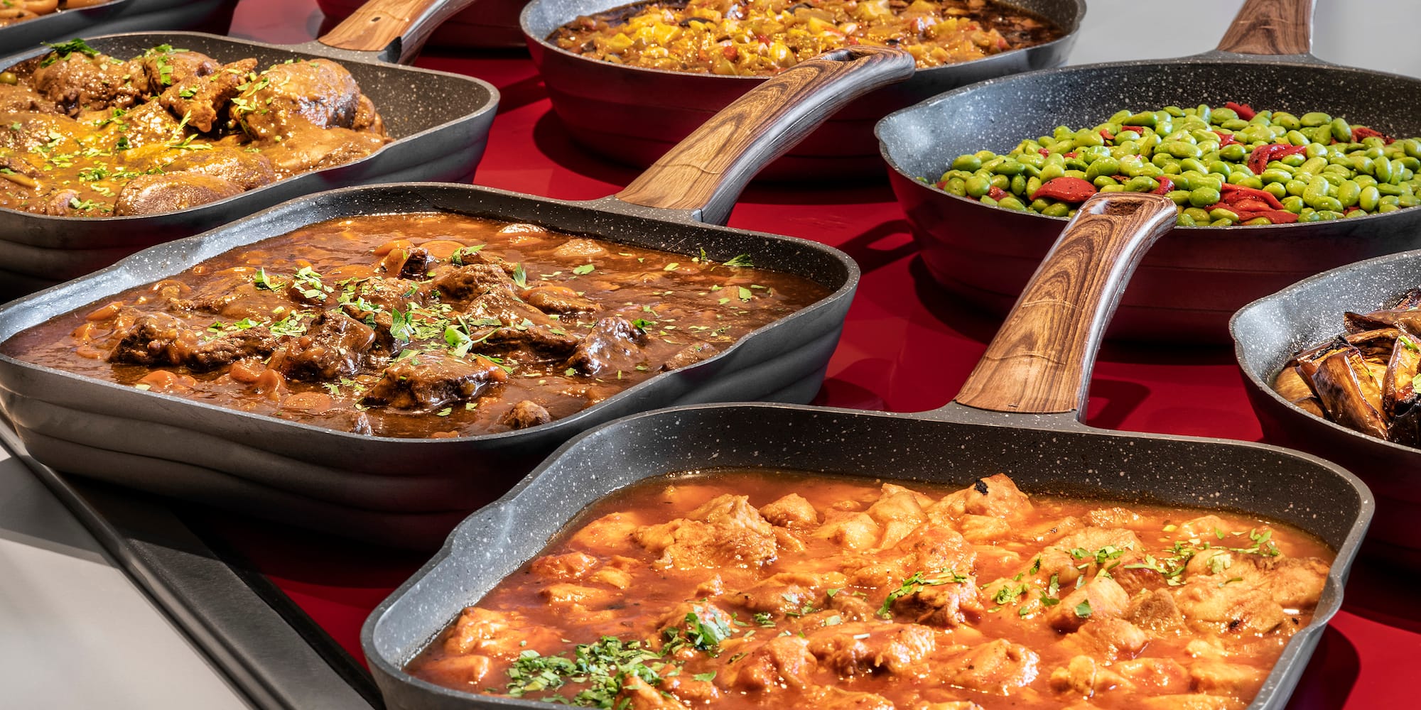 a group of pans with different types of food