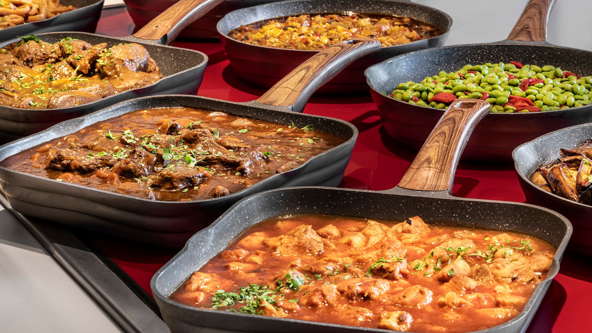 a group of pans with different types of food