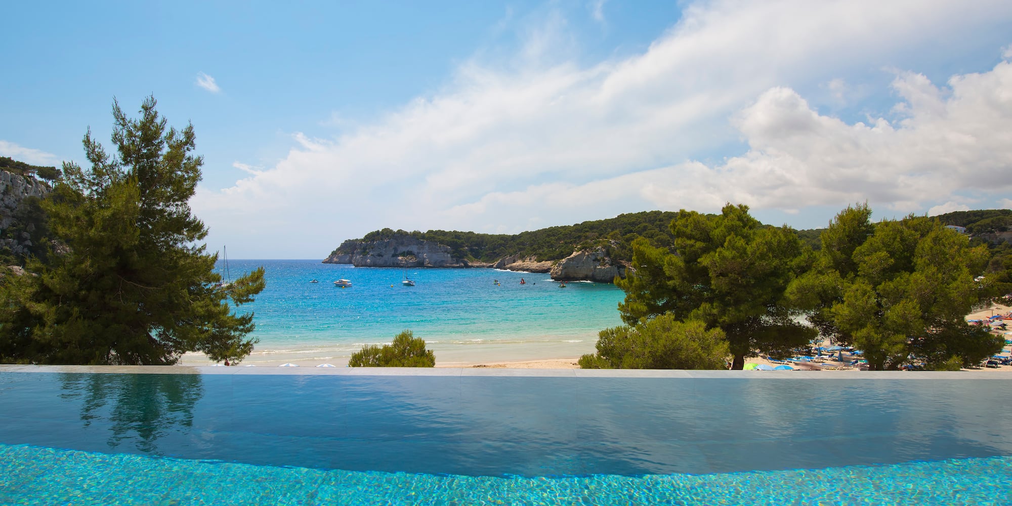 a pool overlooking a beach