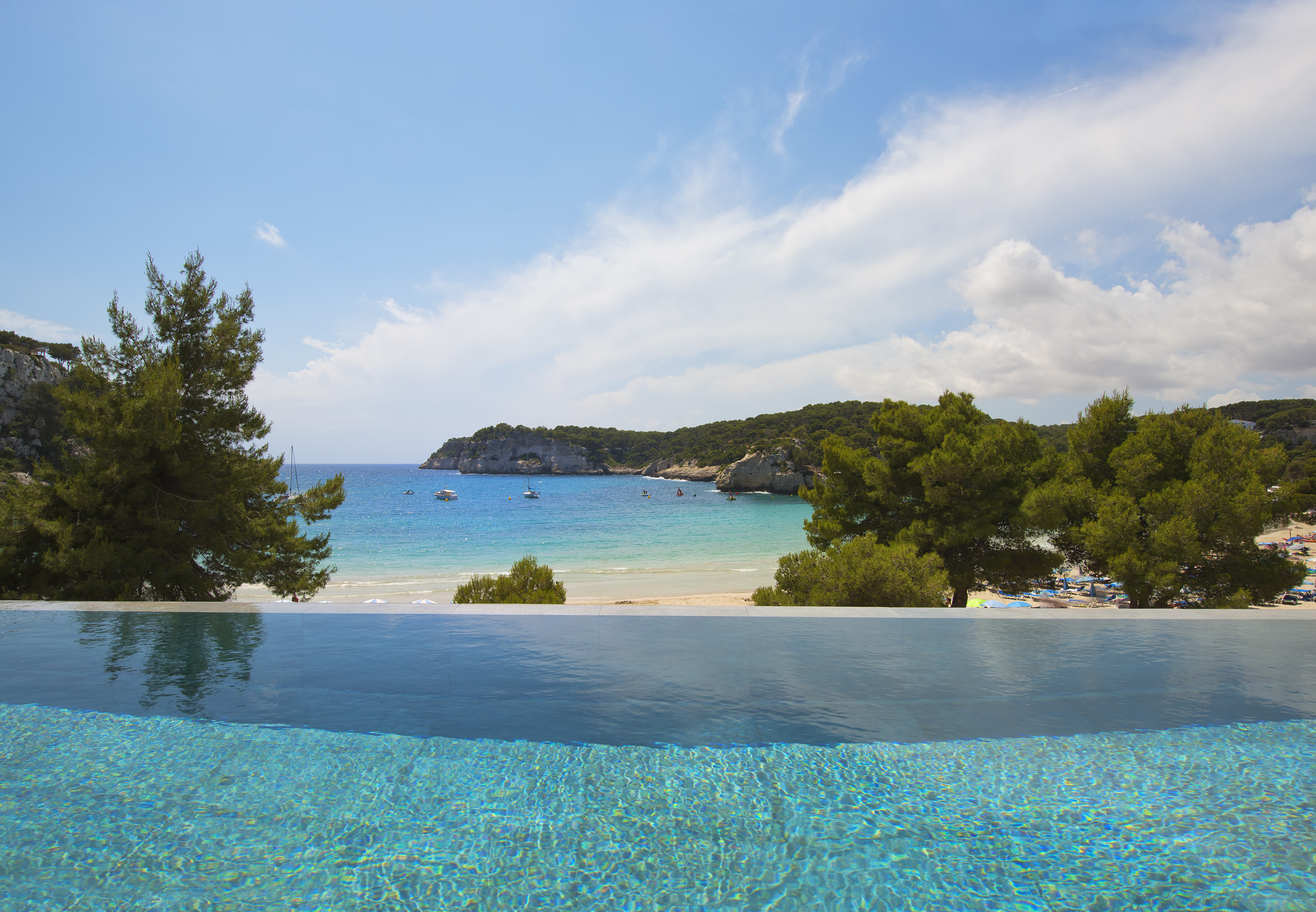 a pool overlooking a beach