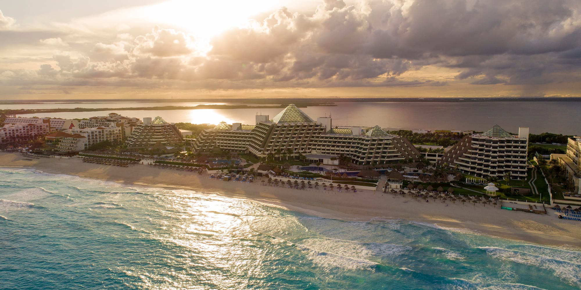 a beach with buildings and water