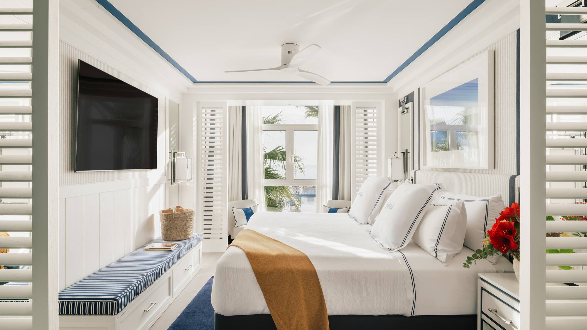 a bedroom with a bed and a television