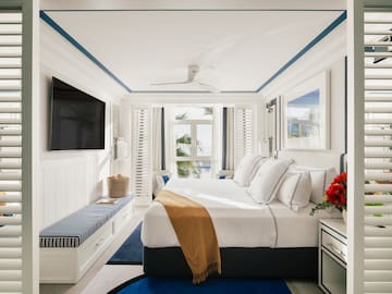 a bedroom with a bed and a television