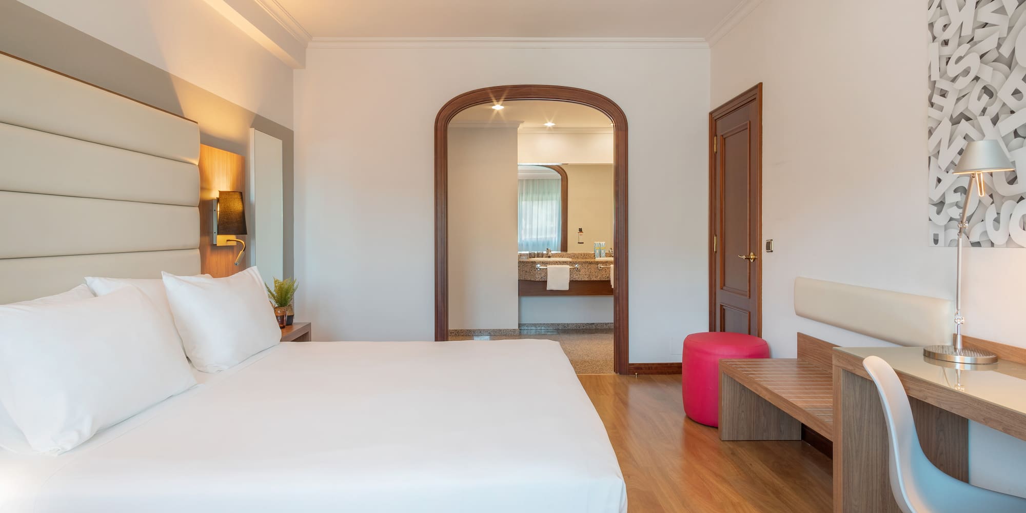 a bedroom with a bed and a bench