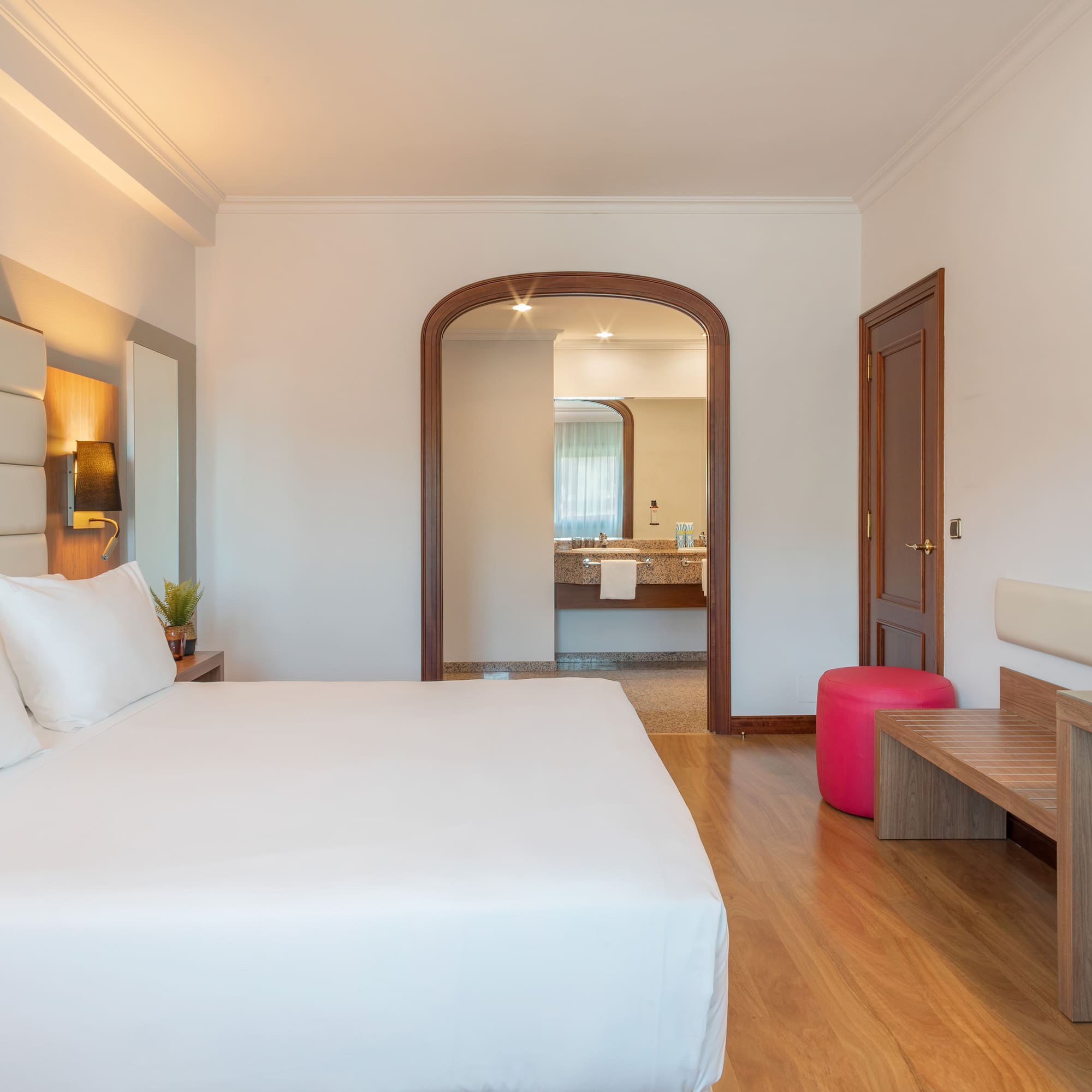 a bedroom with a bed and a bench