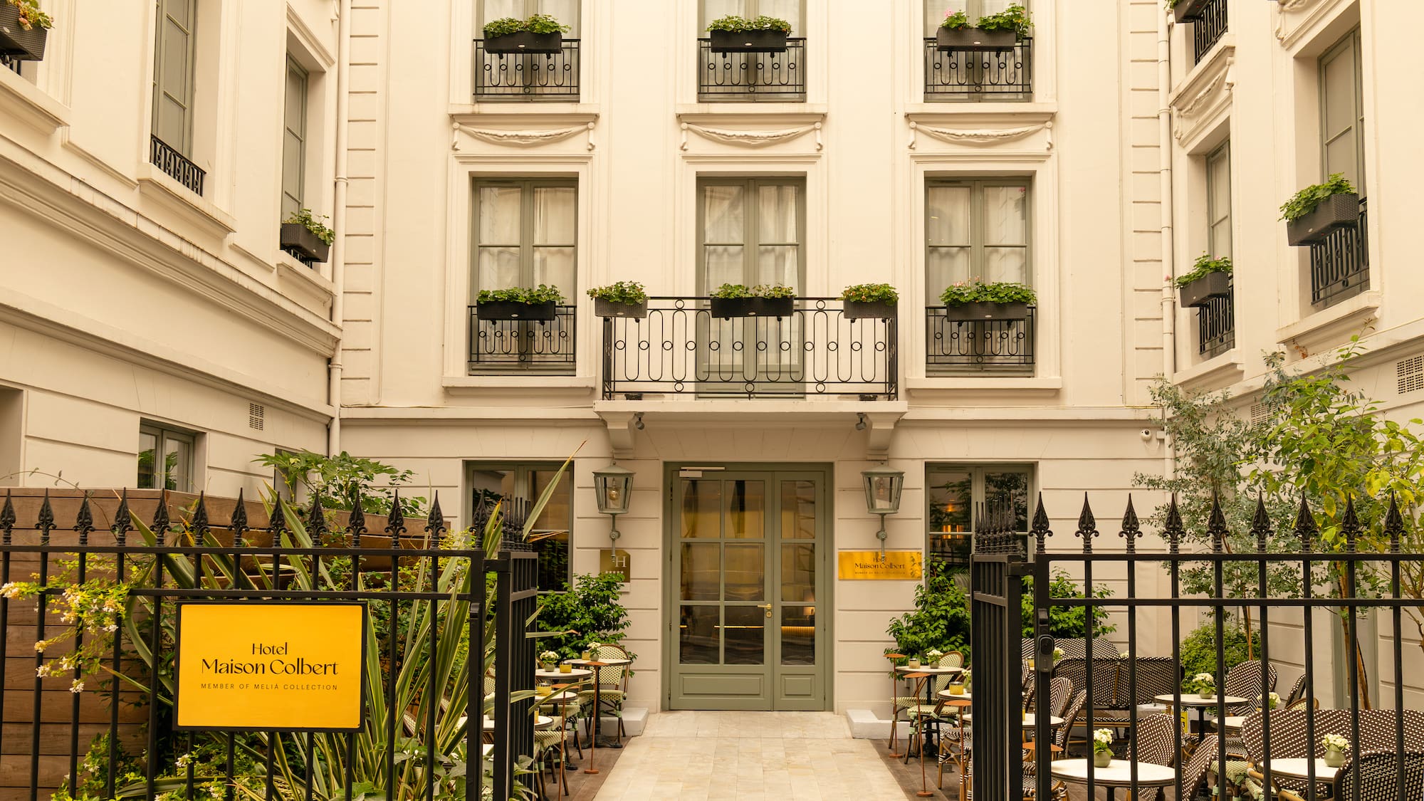 a building with a gate and tables