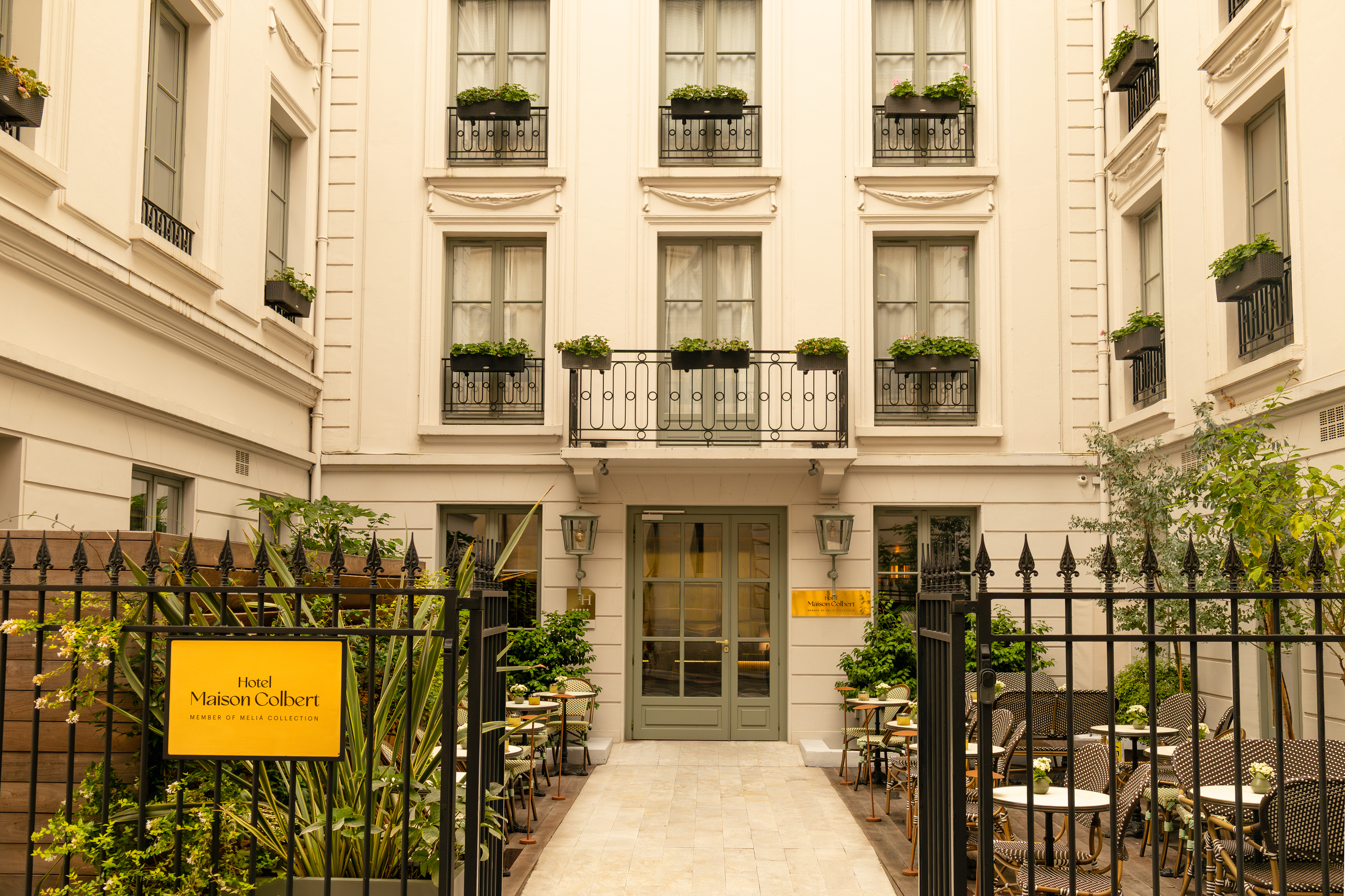 a building with a gate and tables