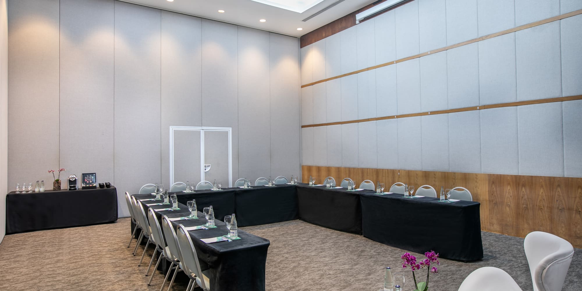 a room with black tablecloths and chairs