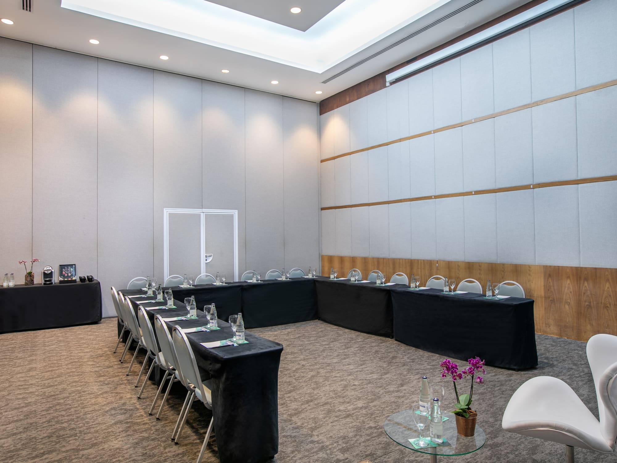a room with black tablecloths and chairs