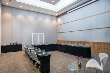 a room with black tablecloths and chairs