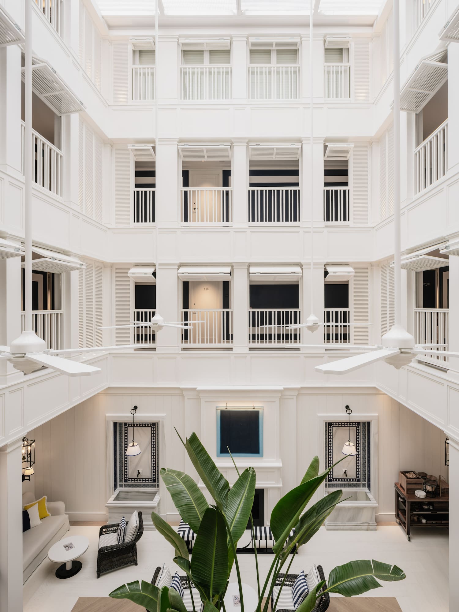 a white building with white walls and ceiling fans