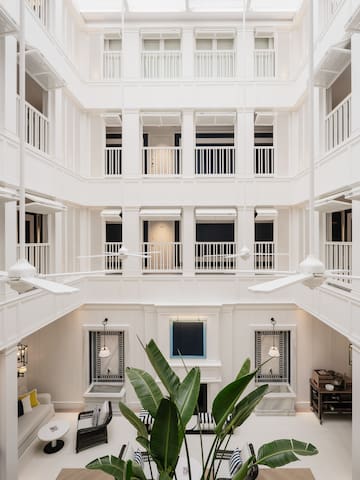 a white building with white walls and ceiling fans