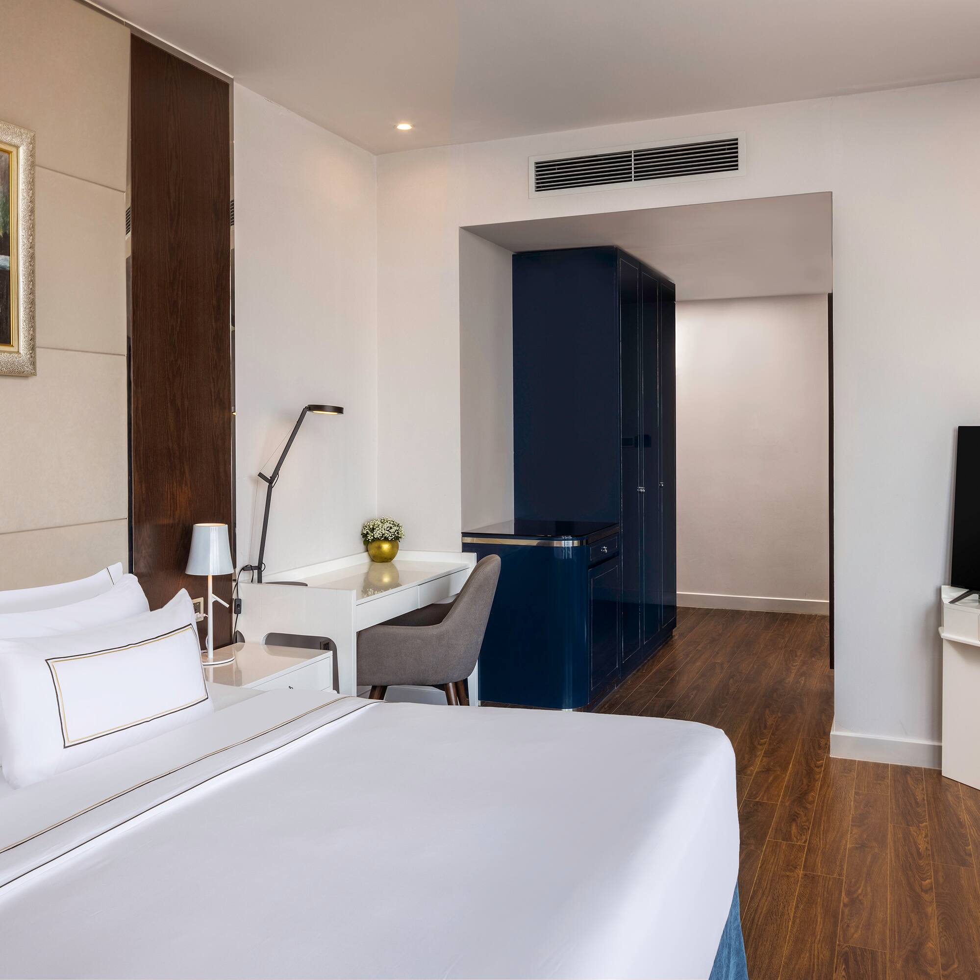 a room with a bed and a tv