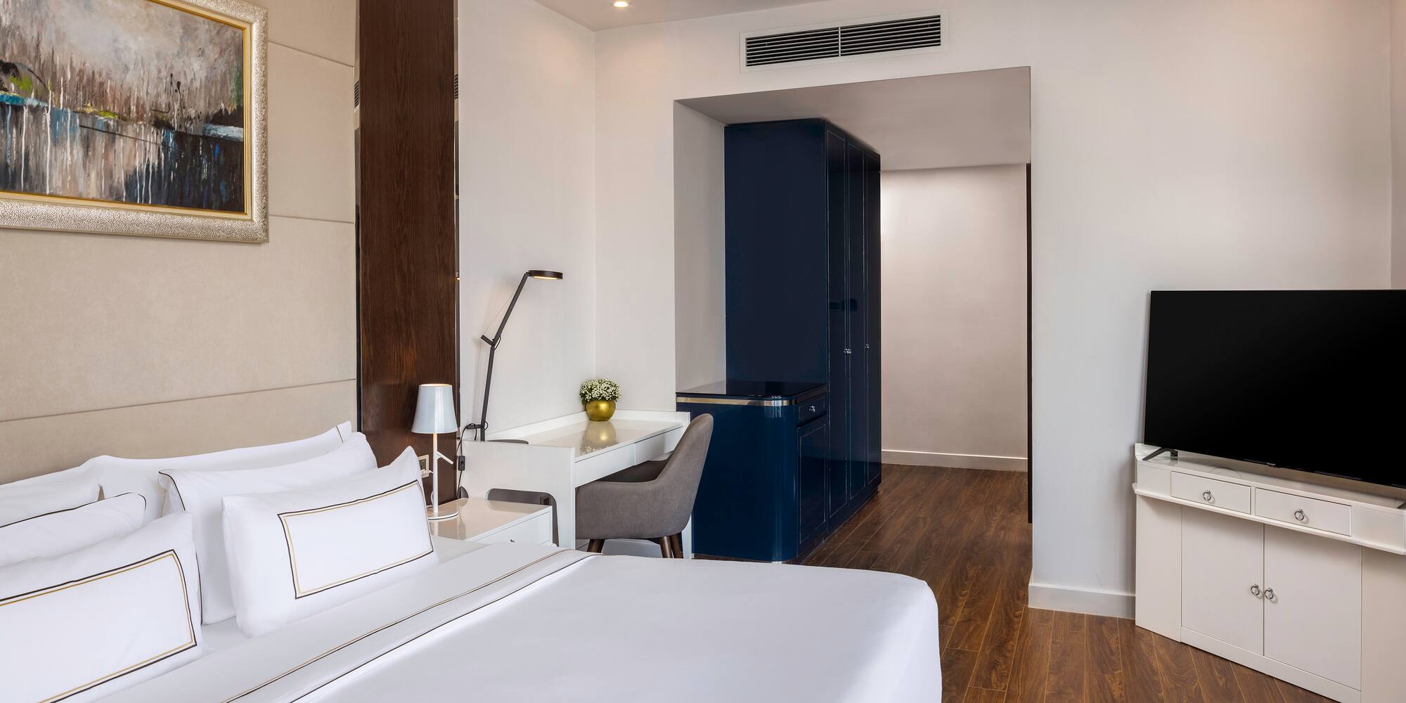 a room with a bed and a tv