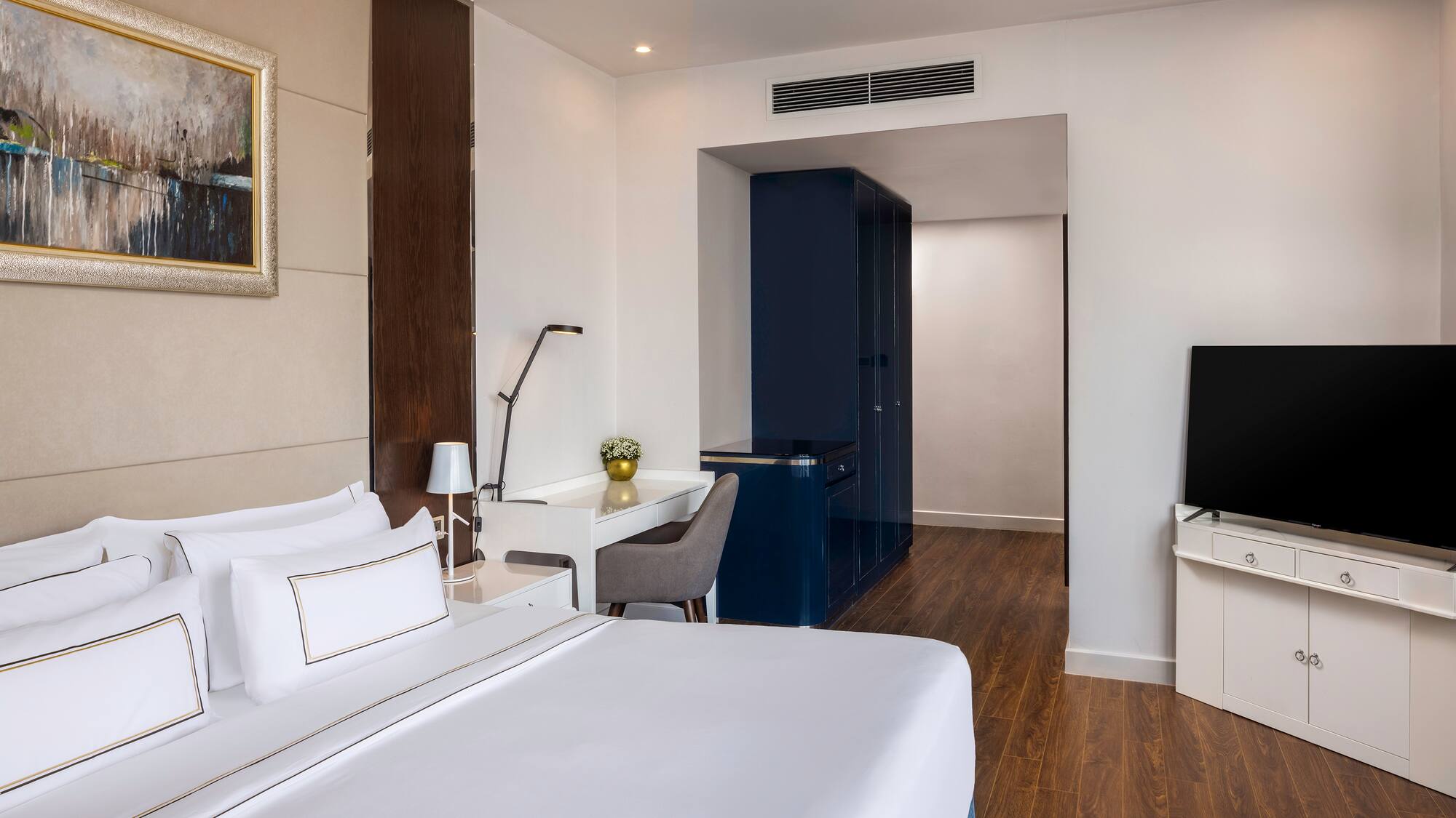 a room with a bed and a tv