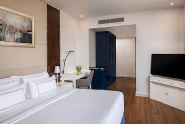 a room with a bed and a tv