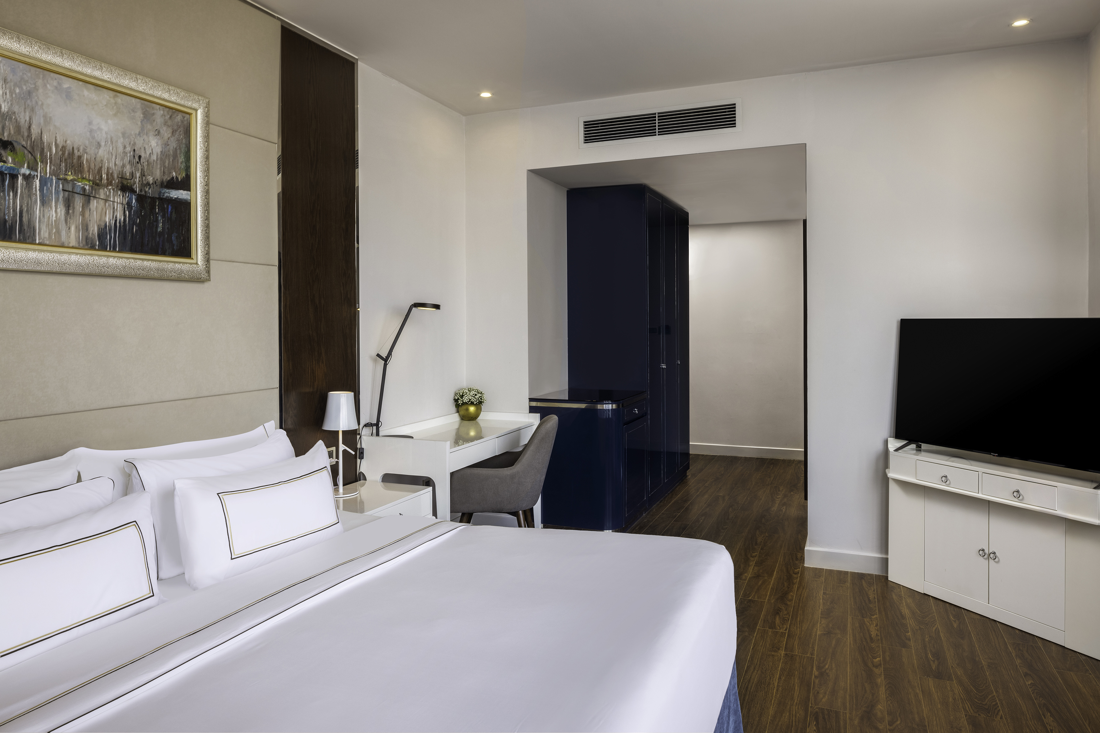 a room with a bed and a tv