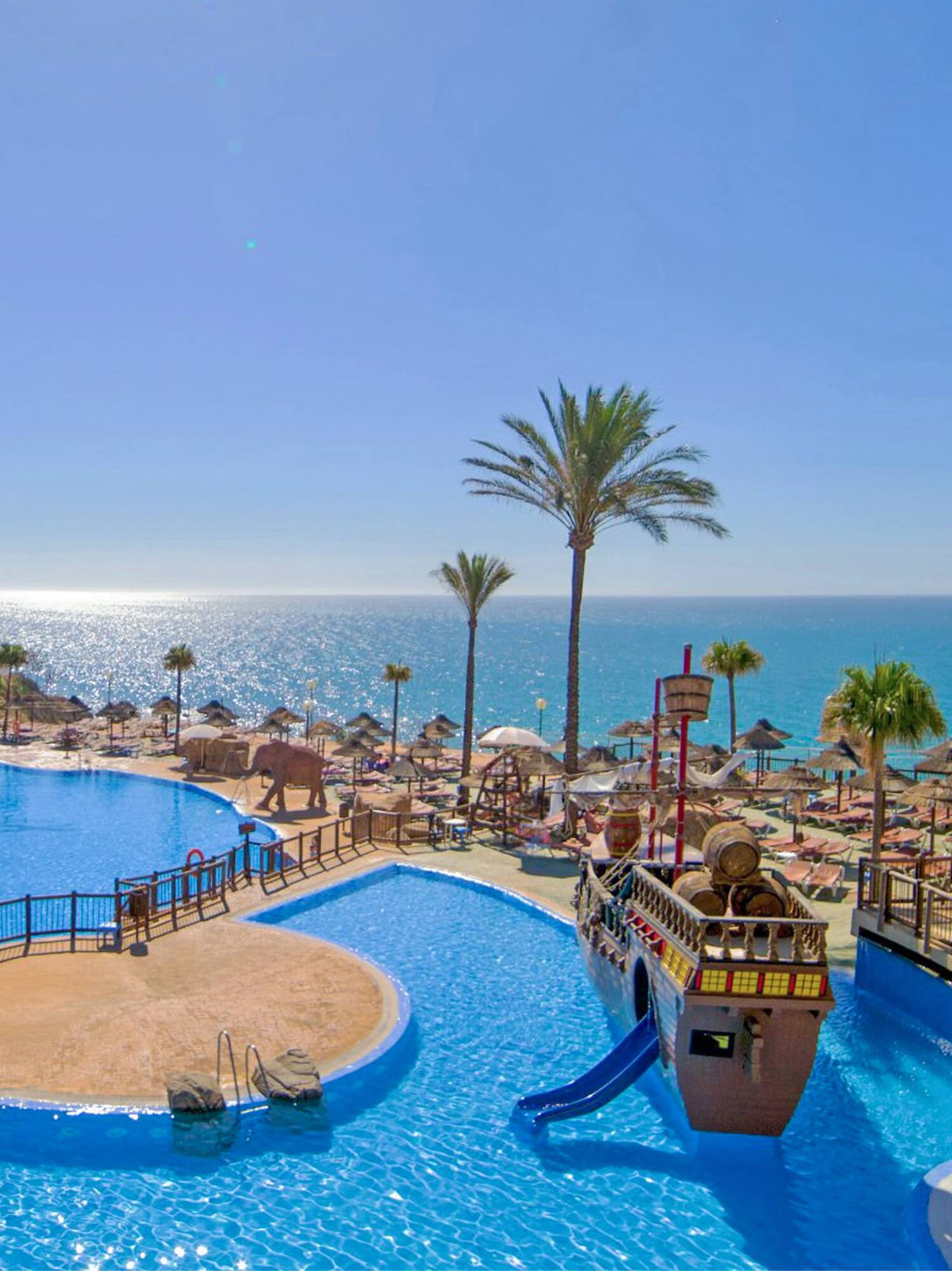 a water park with a slide and a beach