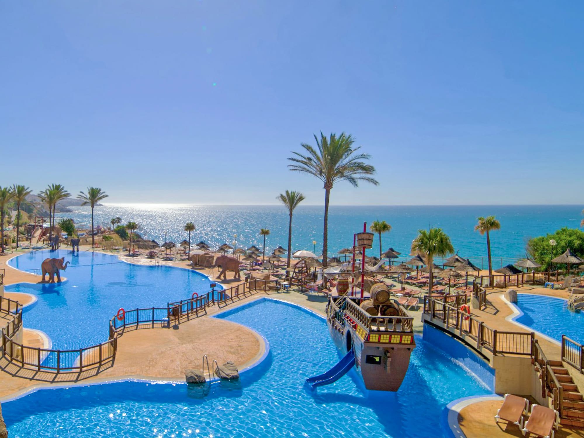 a water park with a slide and a beach