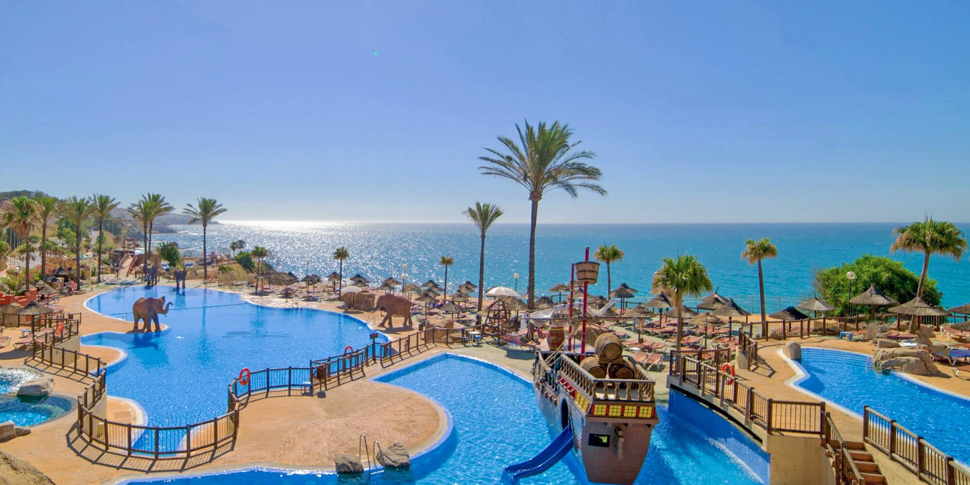 a water park with a slide and a beach