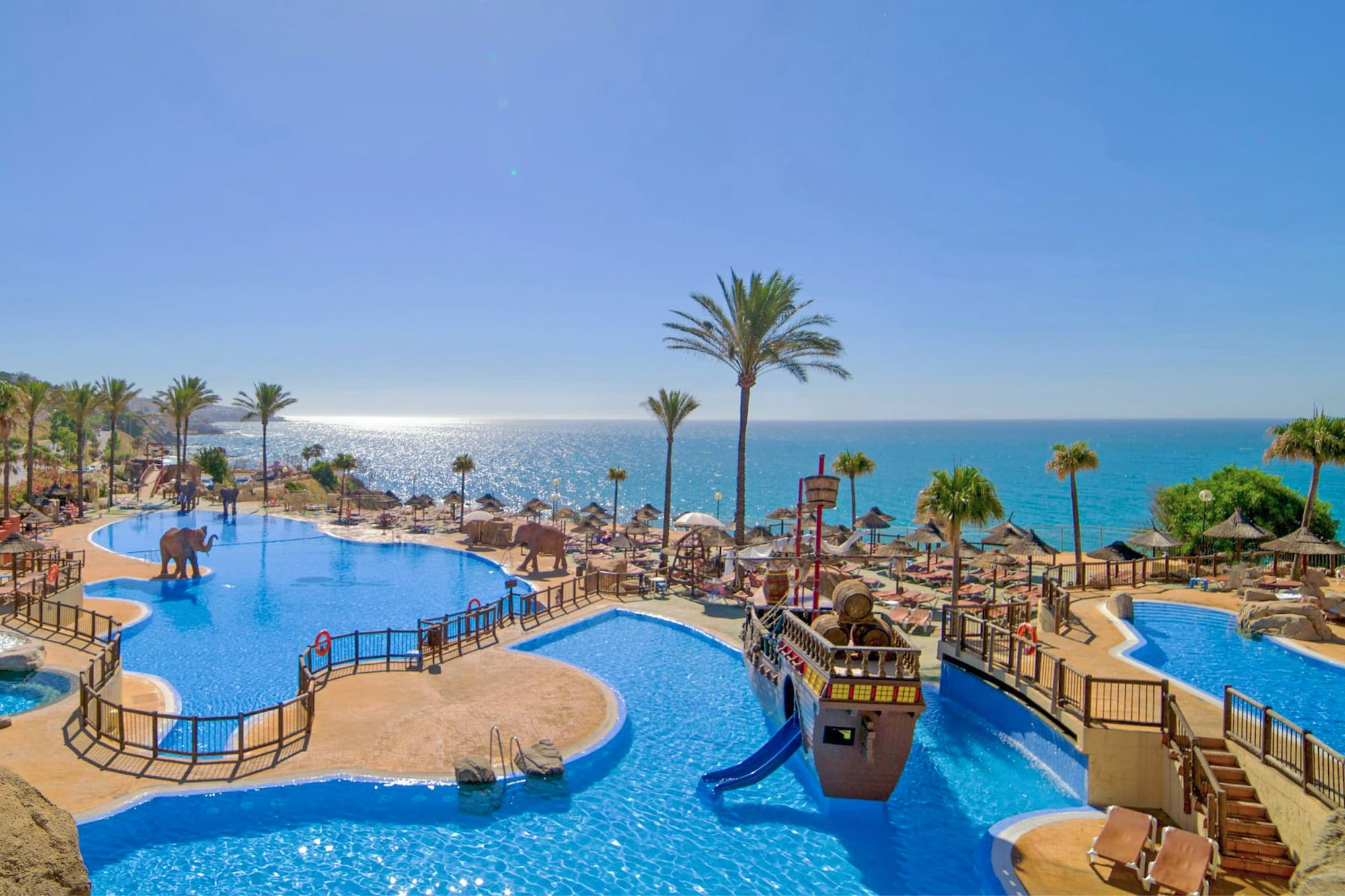 a water park with a slide and a beach