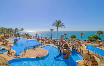 a water park with a slide and a beach