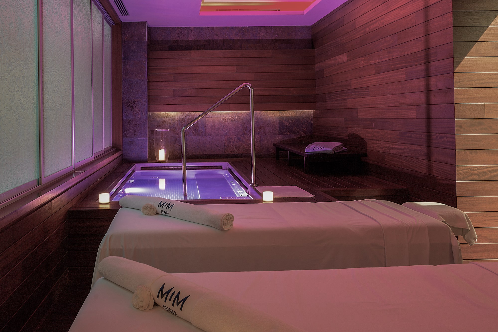 a room with two beds and a hot tub