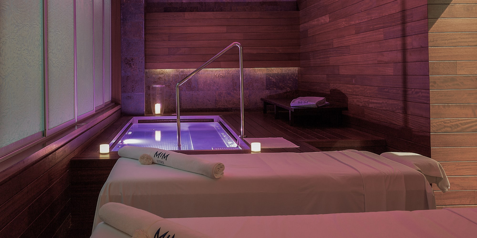 a room with two beds and a hot tub