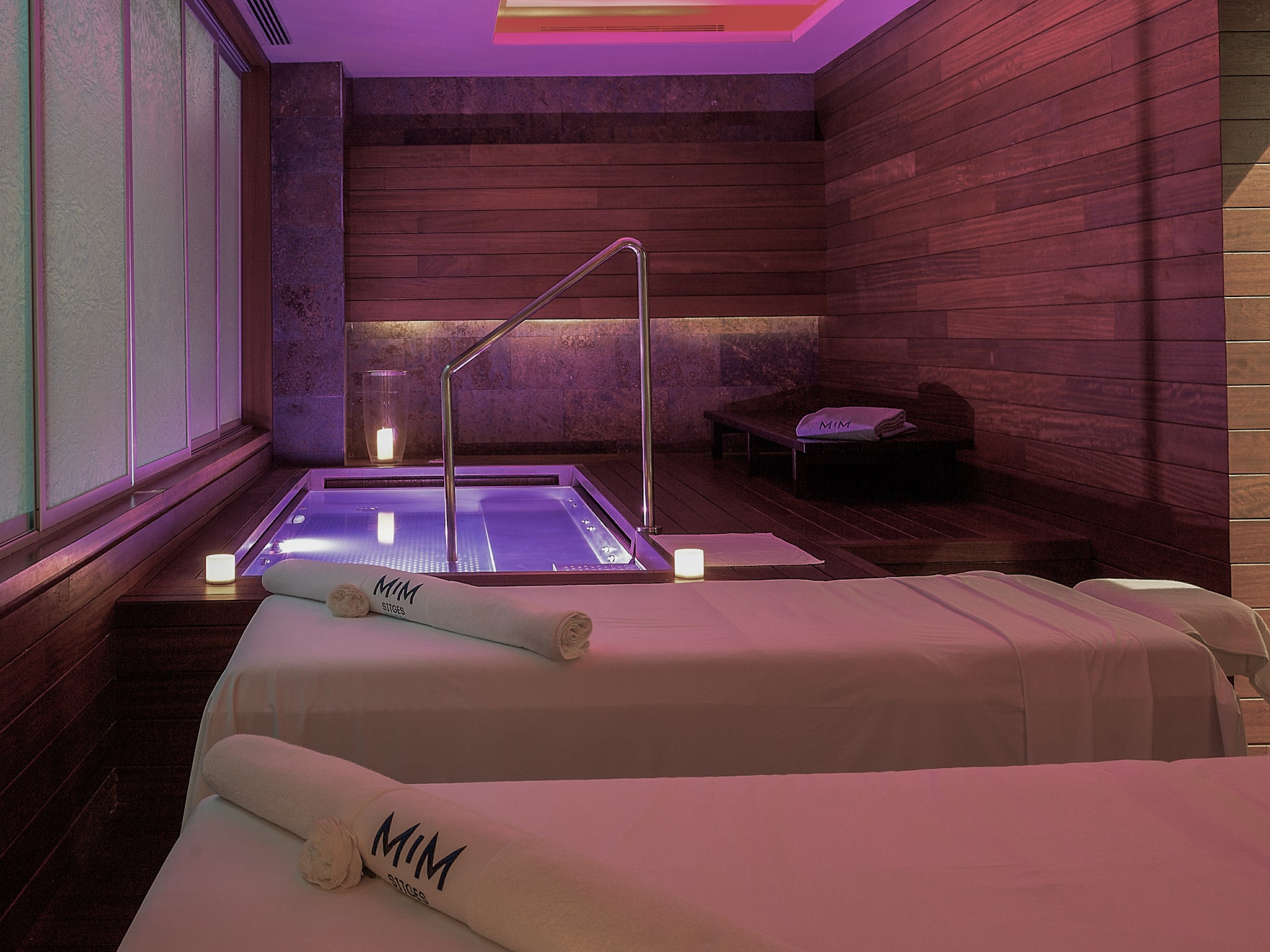 a room with two beds and a hot tub