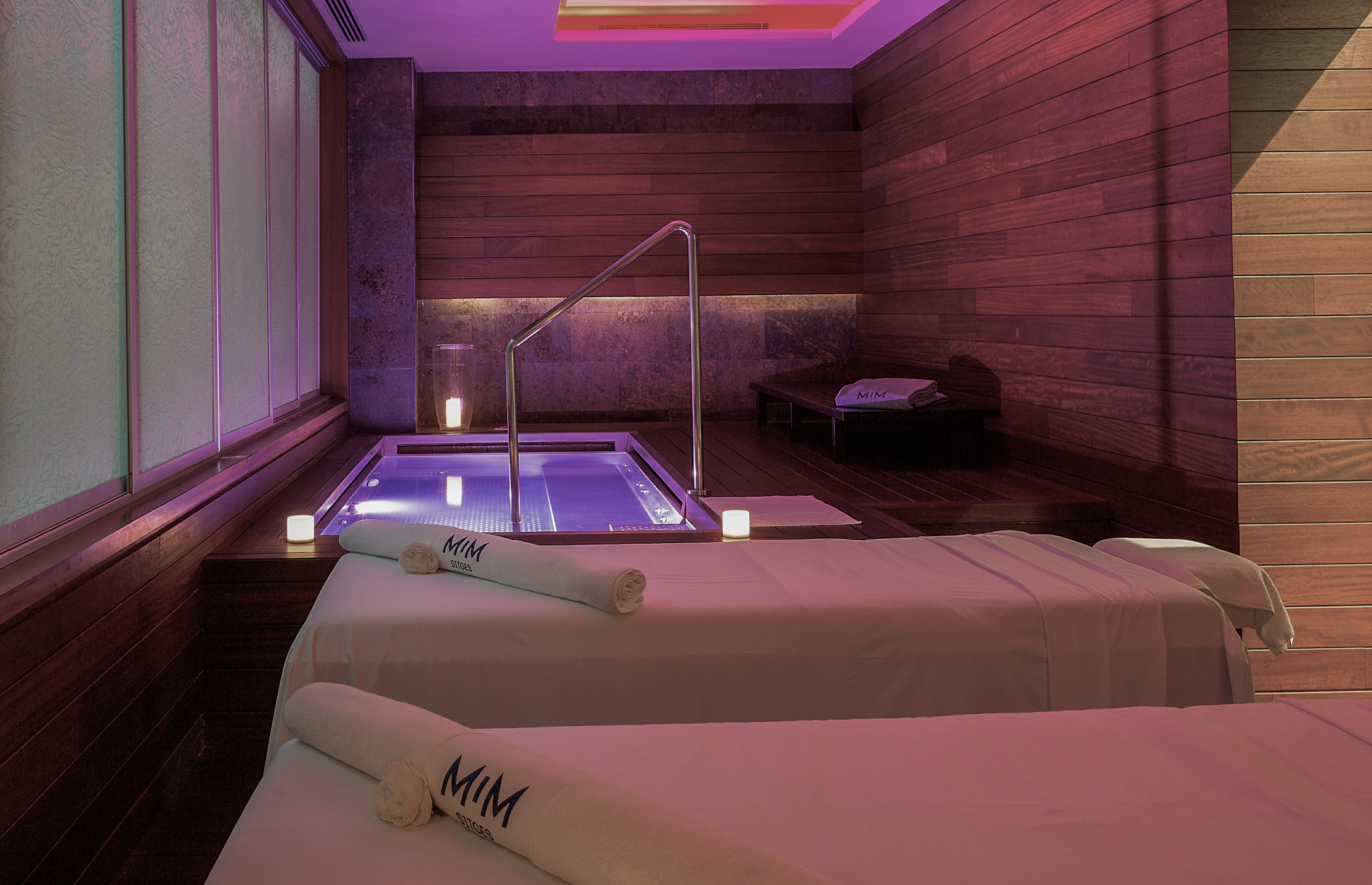 a room with two beds and a hot tub