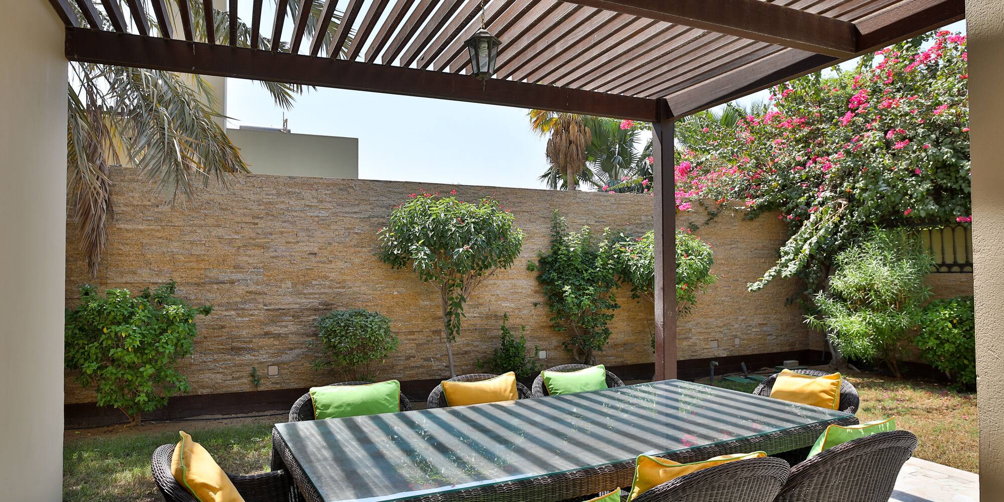 a table and chairs under a covered patio