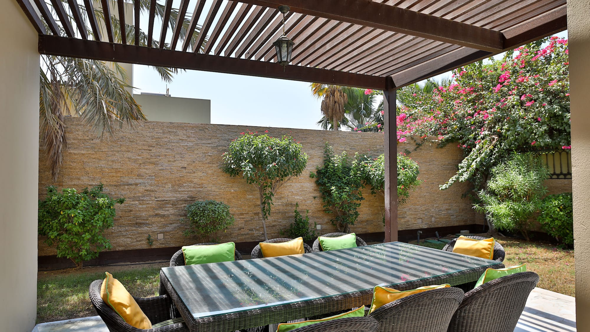 a table and chairs under a covered patio
