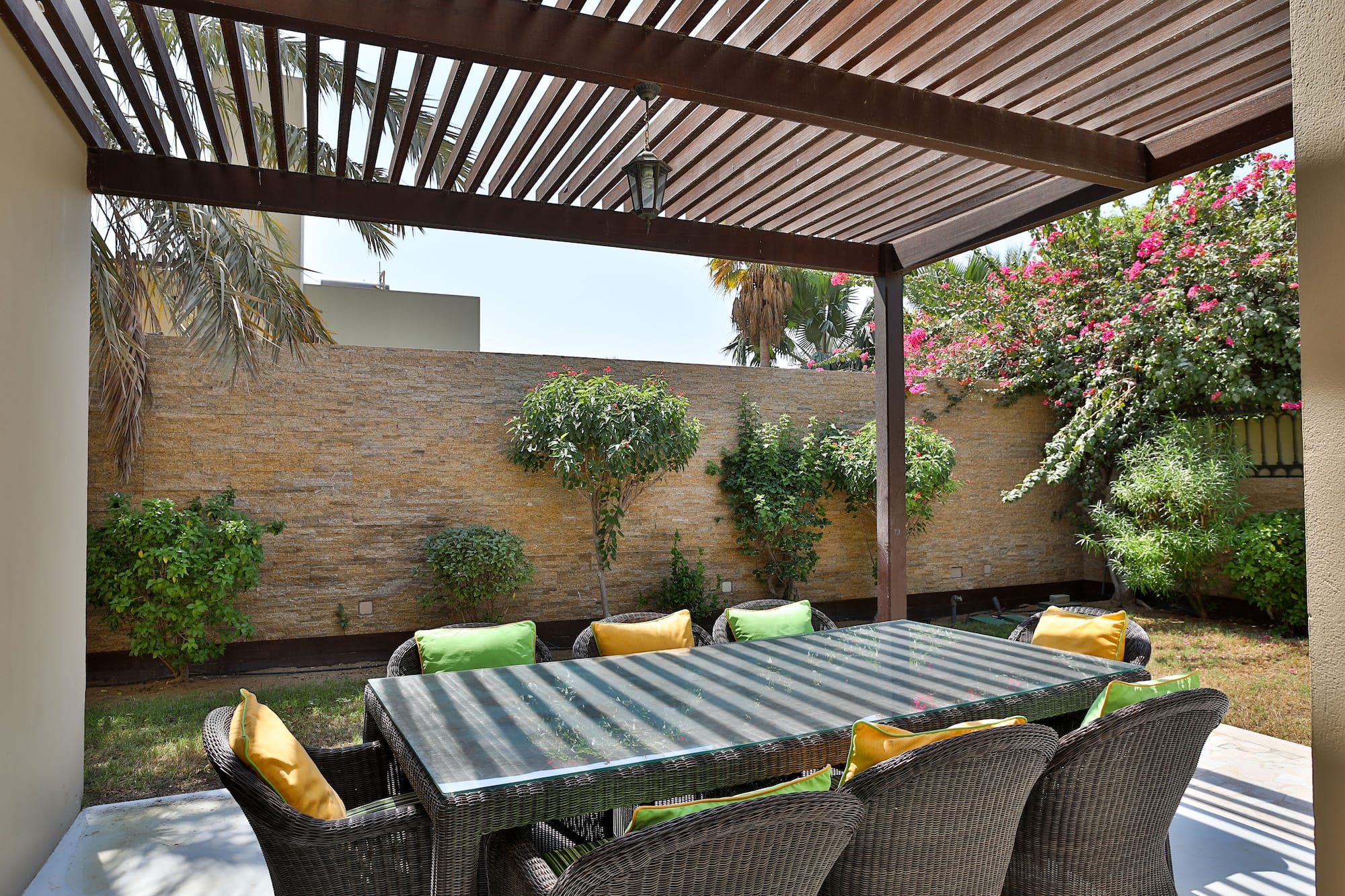 a table and chairs under a covered patio