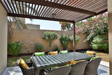 a table and chairs under a covered patio