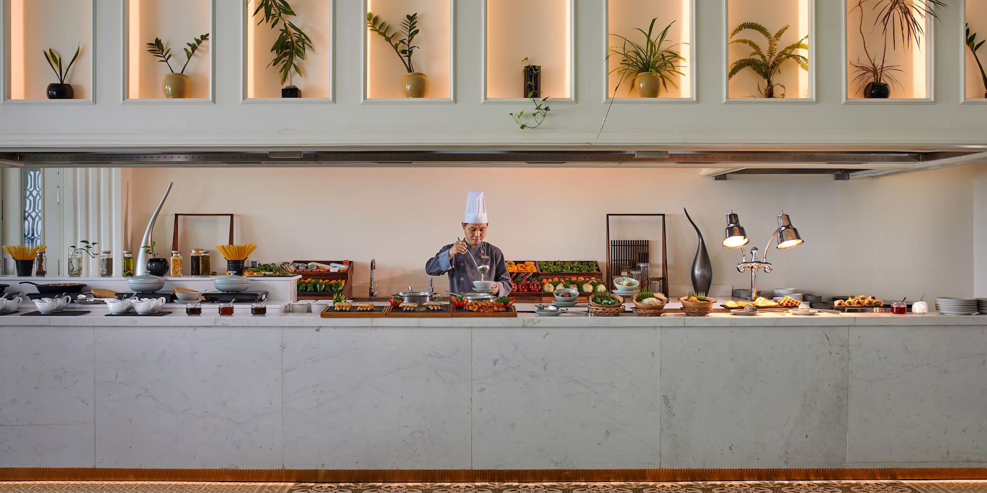 a chef cooking food in a buffet