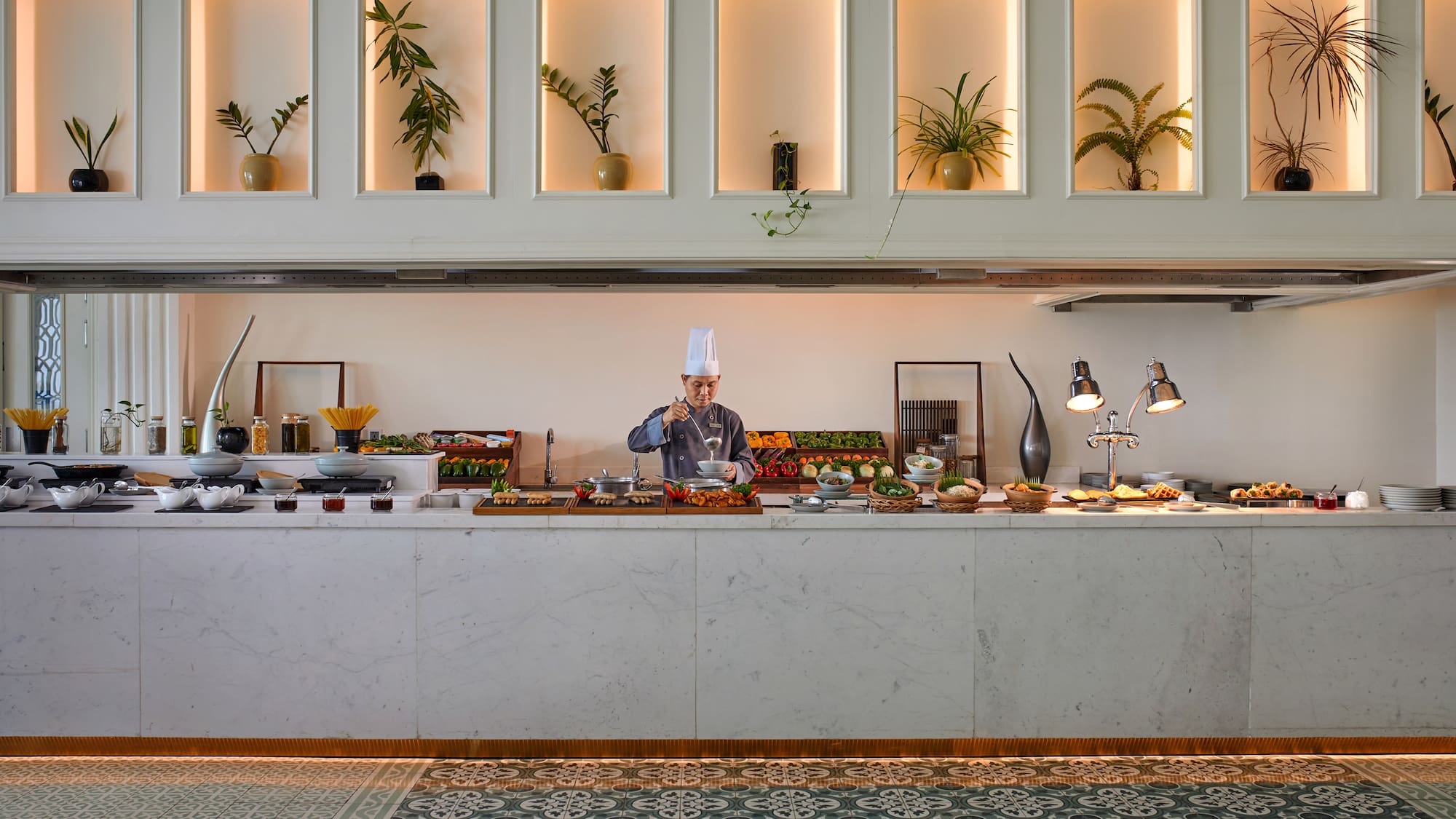 a chef cooking food in a buffet