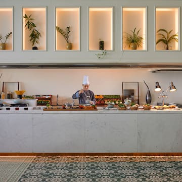 a chef cooking food in a buffet