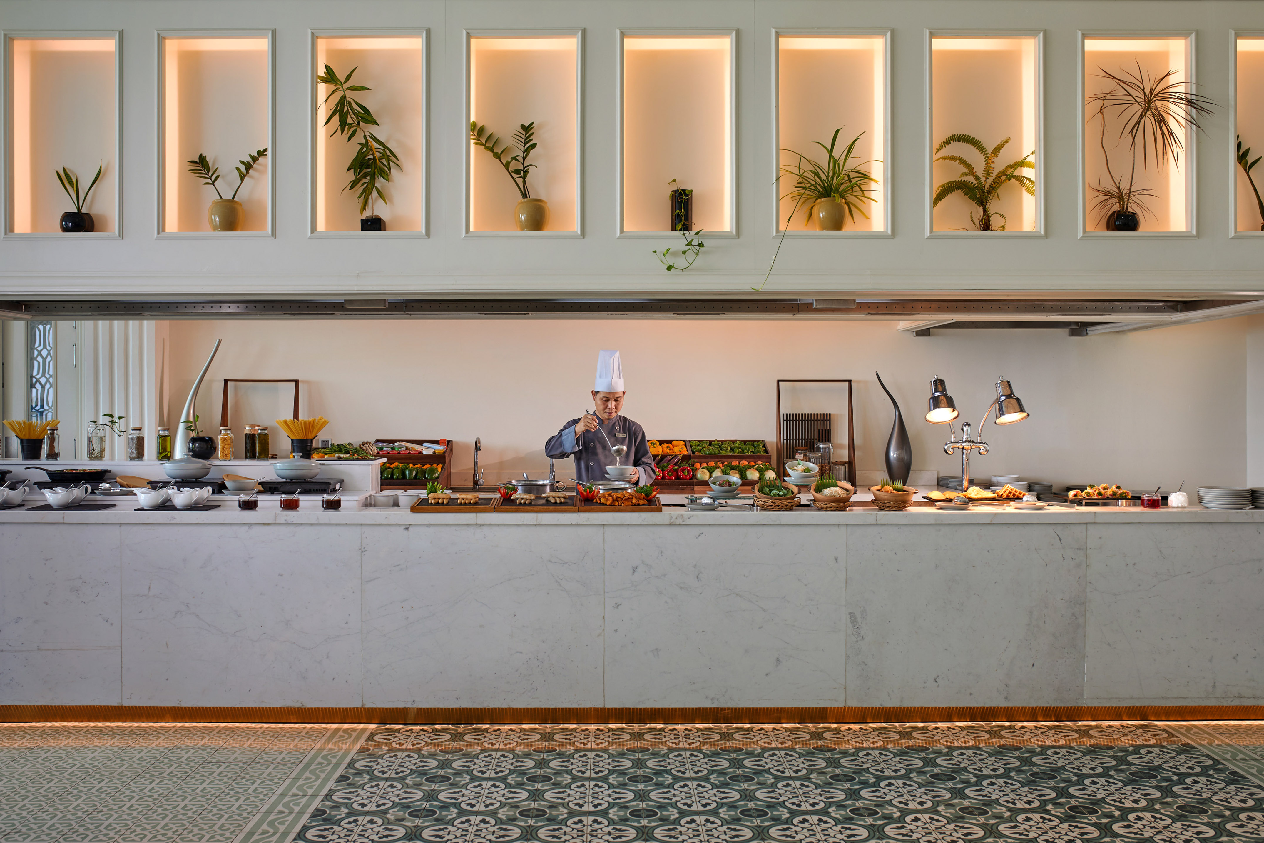 a chef cooking food in a buffet