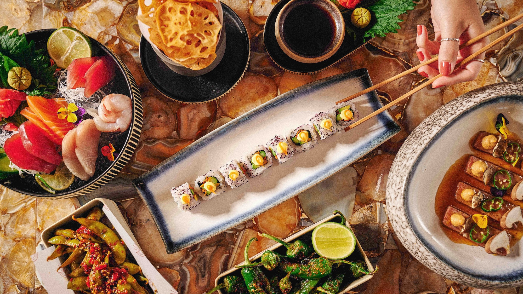 a plate of sushi with chopsticks