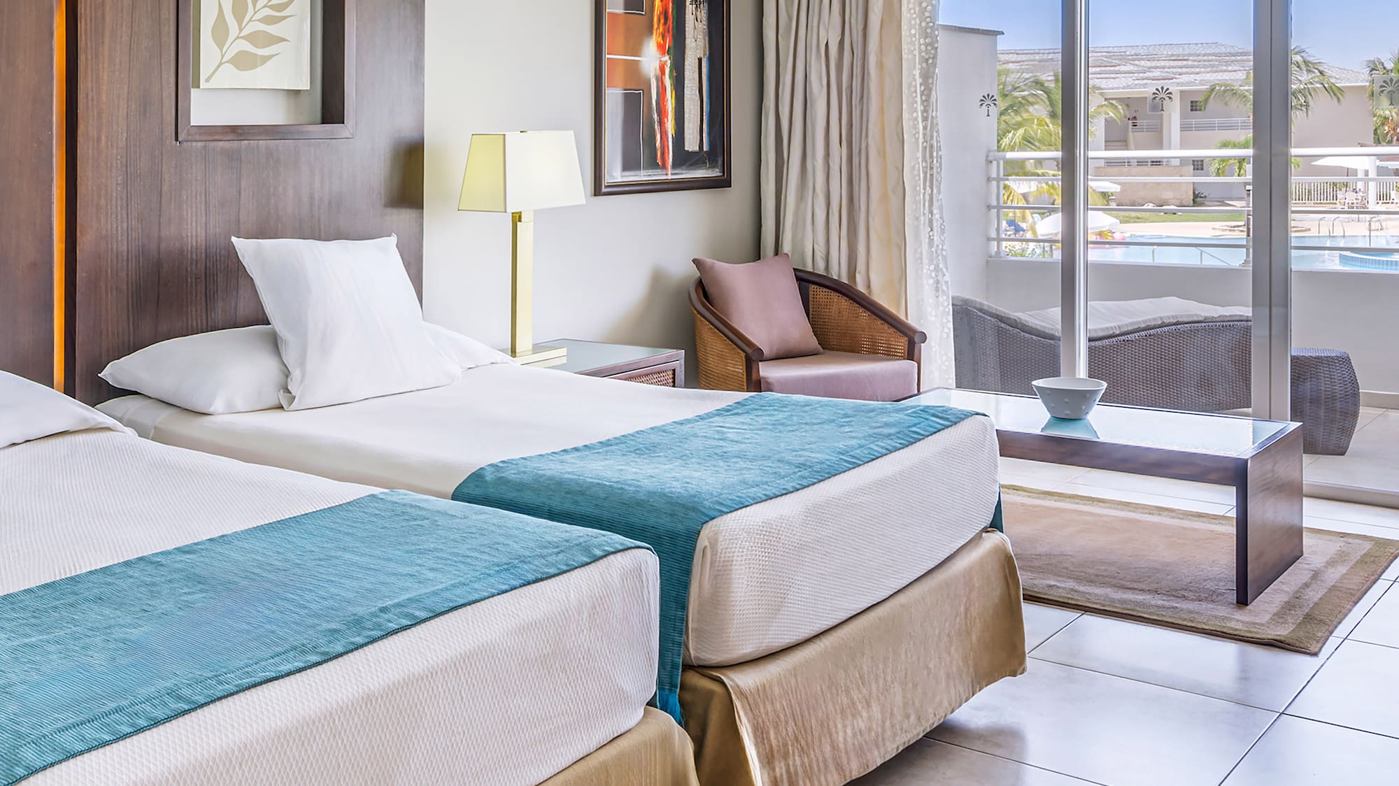 a room with two beds and a glass door