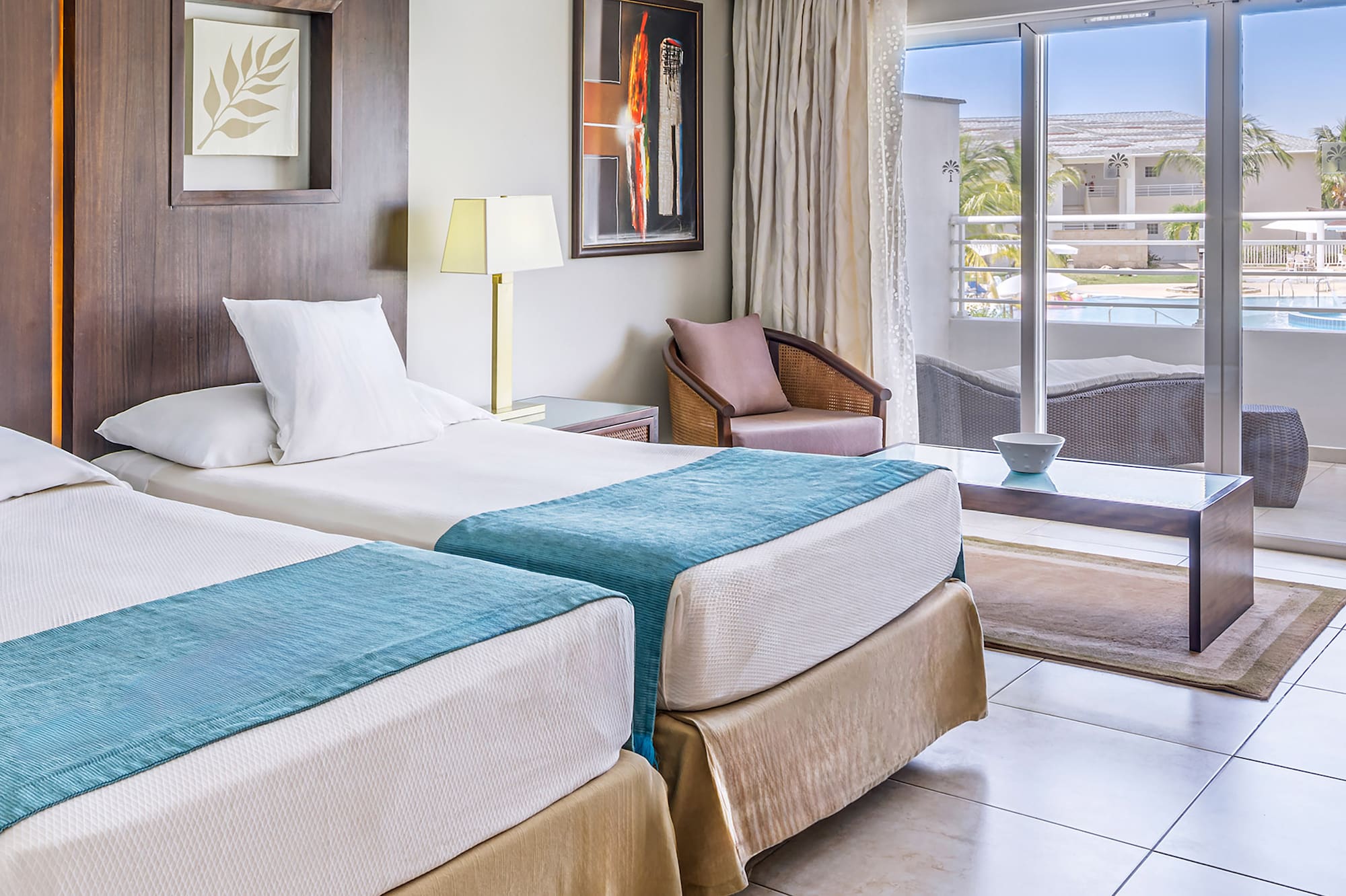 a room with two beds and a glass door