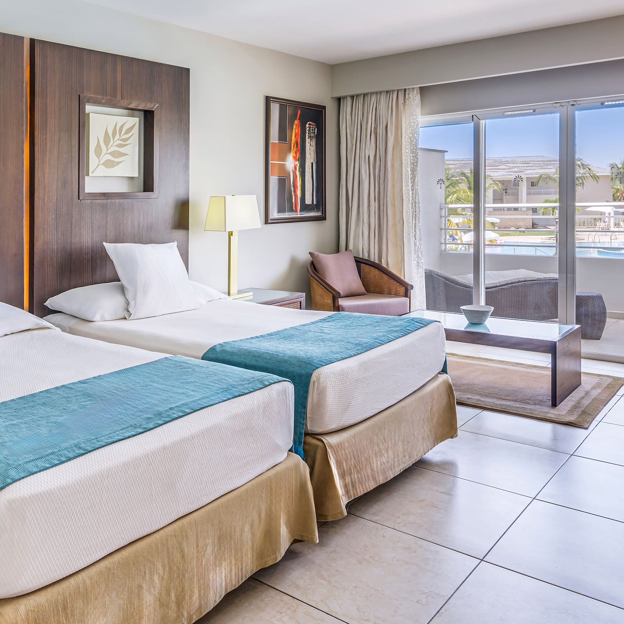 a room with two beds and a glass door