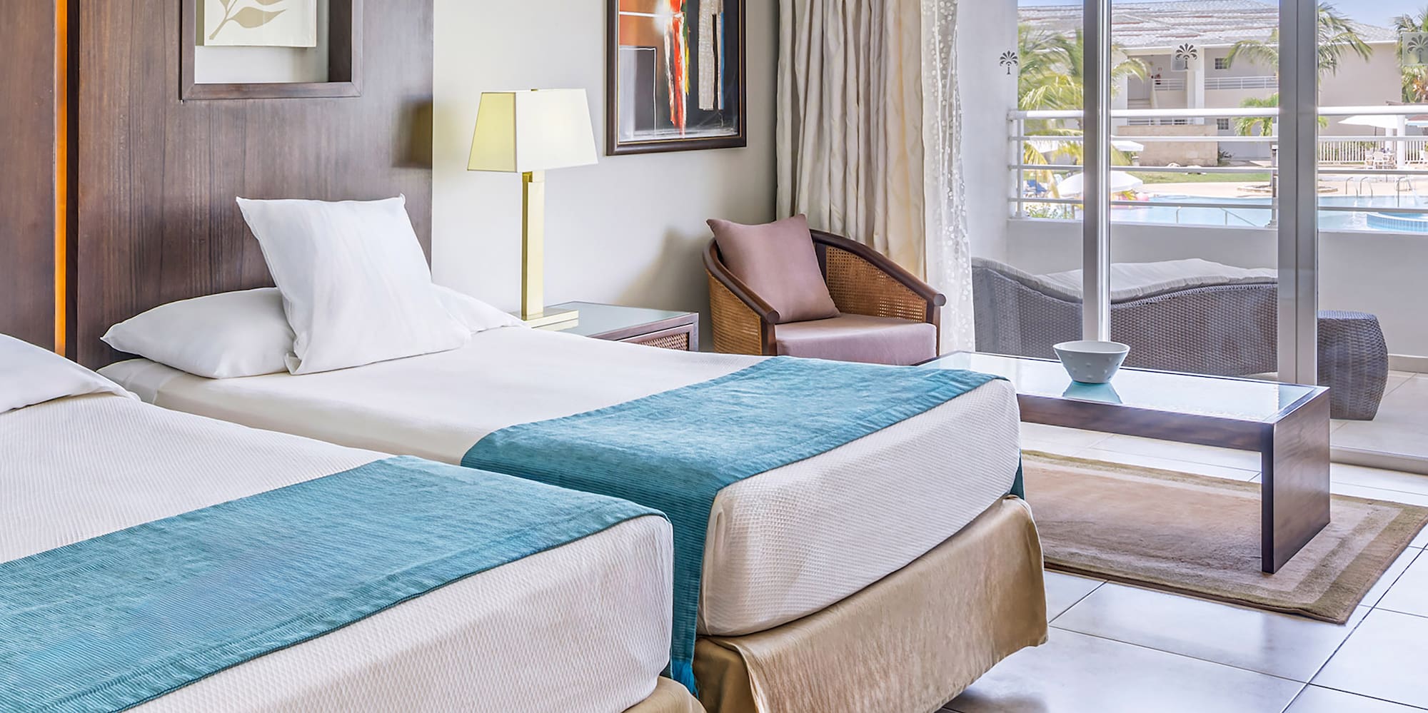 a room with two beds and a glass door