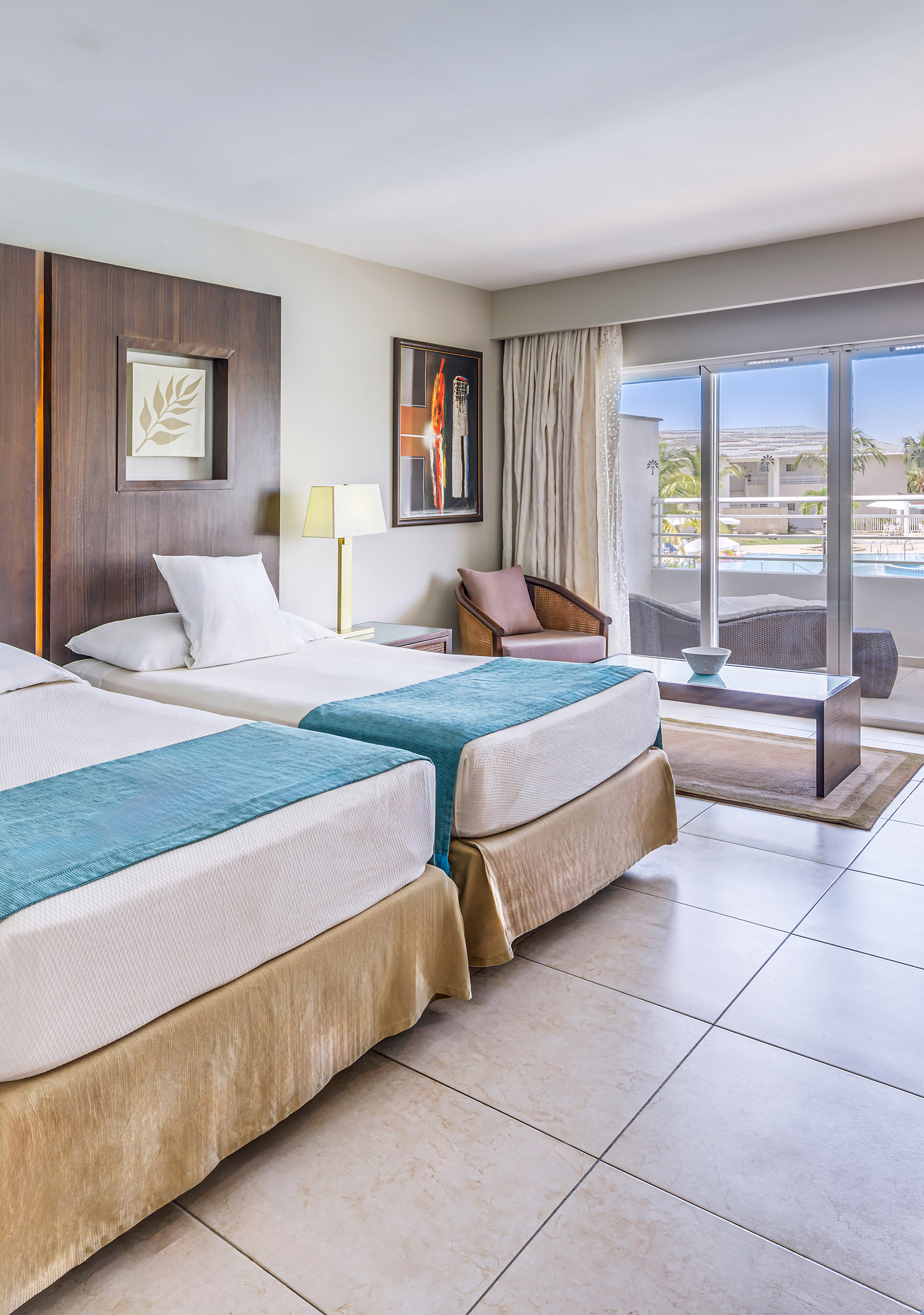 a room with two beds and a glass door