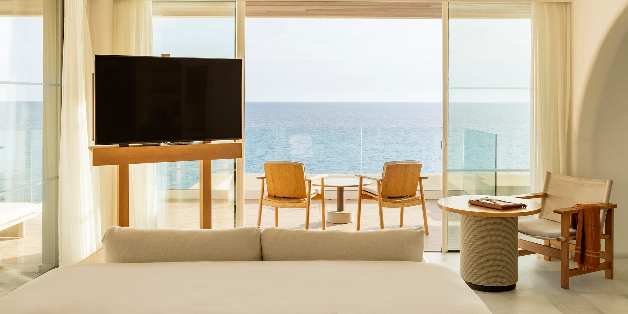 a room with a television and a table and chairs