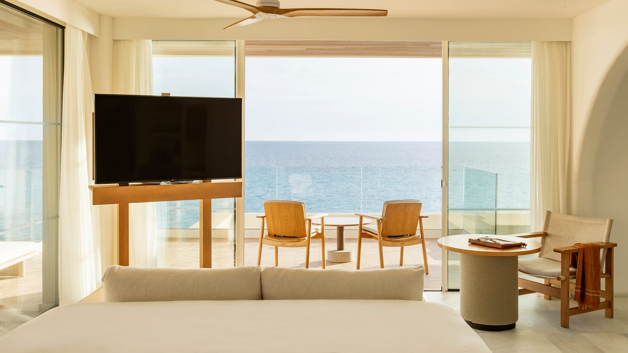 a room with a television and a table and chairs