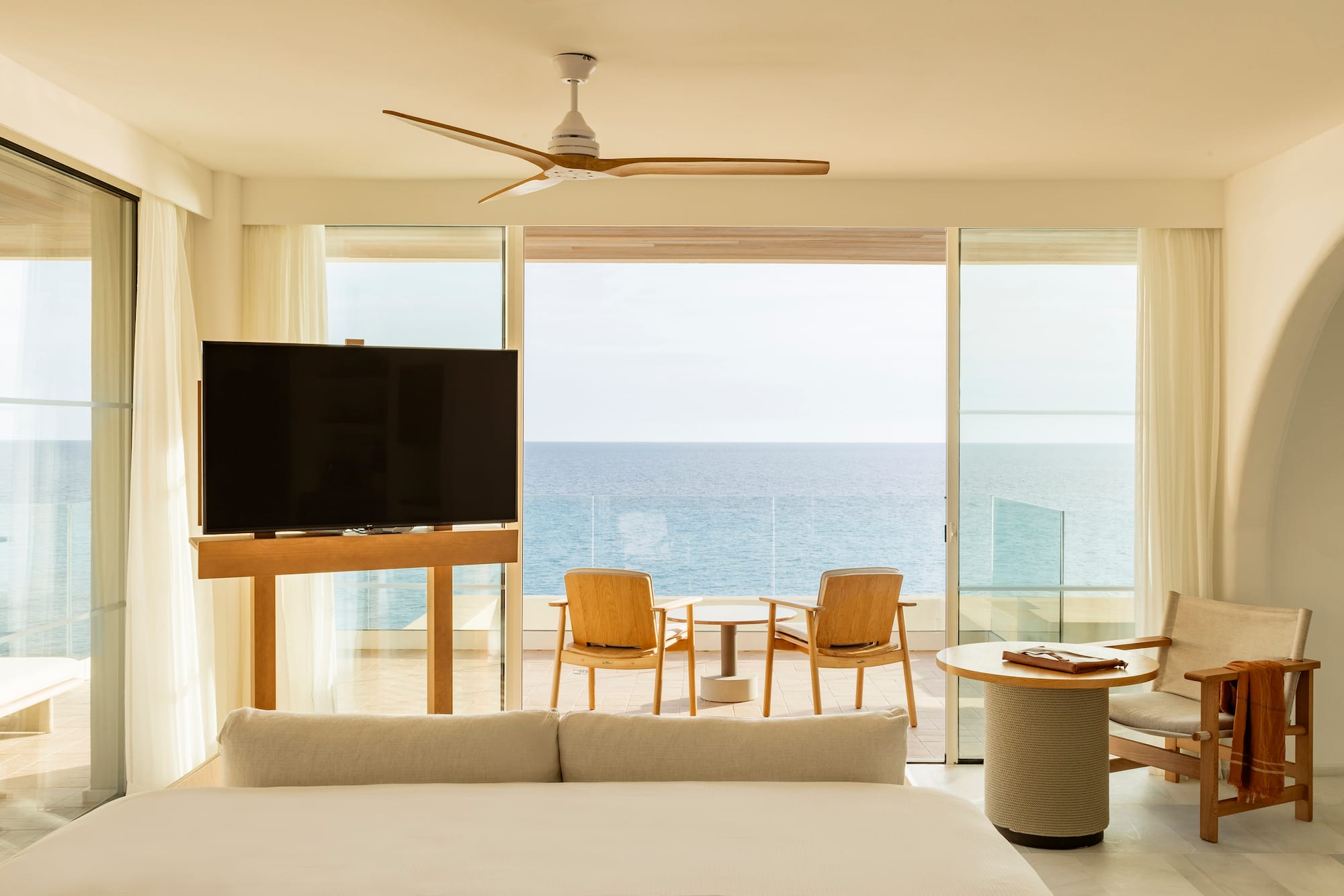 a room with a television and a table and chairs