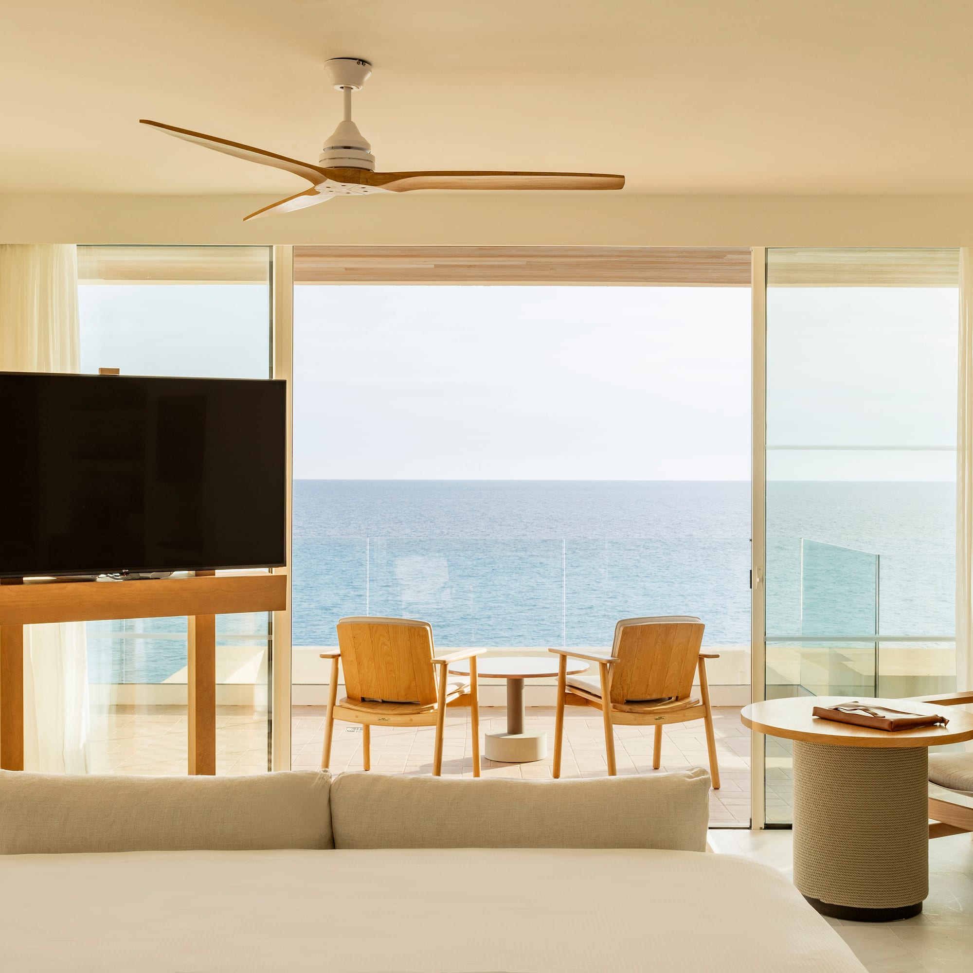 a room with a television and a table and chairs